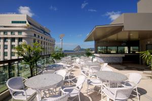 a row of tables and chairs on a balcony at Hotel Atlântico Business Centro in Rio de Janeiro