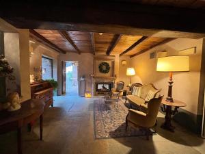 a living room with a couch and a fireplace at Locanda Maison Verte in Cantalupa