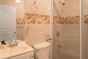 a bathroom with a shower and a toilet and a sink at Villa Gumio 2BR Apt- 7 min walk to Boca Chica Beach apts in Boca Chica