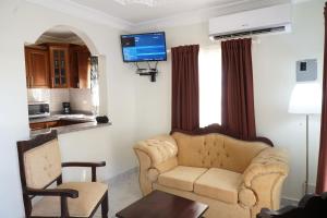 a living room with a couch and a tv at Villa Gumio 2BR Apt- 7 min walk to Boca Chica Beach apts in Boca Chica