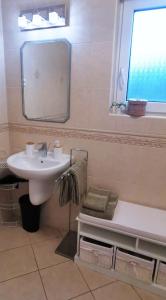 a bathroom with a sink and a mirror and a tub at Mediterrania Apartment in Keszthely