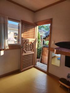 an empty room with a door open to a balcony at Beautiful House in Jeonju