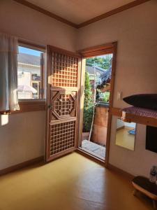 an empty room with a door open to a balcony at Beautiful House in Jeonju +48 photos