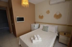 a bedroom with a bed with towels on it at ŞEREF APART MOTEL in Marmara