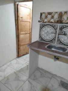 a bathroom with a sink and a clock on the wall at Abu Salem Garden- كرم ابو سالم in Saint Catherine