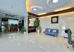 un'ampia hall con divano e sedie blu di Cheryl's Place Vacation Home Palawan a Città di Puerto Princesa