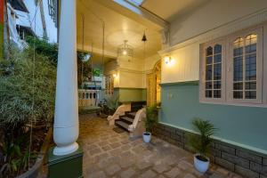 - un hall d'une maison avec une terrasse couverte dotée de bancs dans l'établissement Zostel Kochi, Fort Kochi, à Cochin