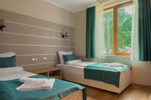 a hotel room with two beds and a window at Vemara City Boutique Hotel-free parking in Varna City +61 photos