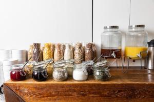 a counter with jars of food and other food items at Sophie's Hostel in Prague
