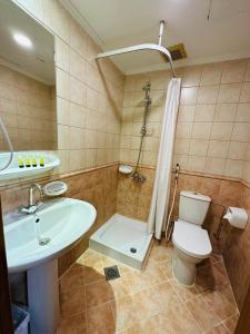 a bathroom with a sink and a toilet and a shower at Nada Al Majd Hotel in Makkah