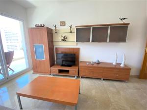 a living room with a tv and a coffee table at Gemelos 22-1-5 in Benidorm