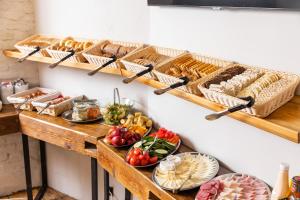 a table filled with lots of different types of food at Sophie's Hostel in Prague