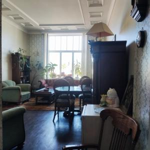 a living room with a table and chairs at Ventspils apartamenti pie Rātslaukuma in Ventspils