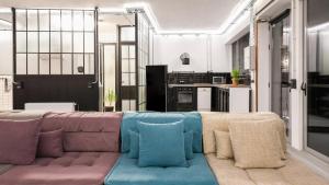 een woonkamer met een bank en een keuken bij Monastiraki #WallsFree CityCenter- Unspoiled Athens Apartments in Athene