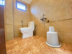 a bathroom with a toilet and a sink in it at La Paradise Luxury in Puducherry