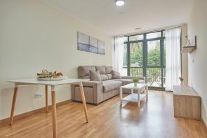 a living room with a couch and a table at Apartagal-San Miguel Barreiros in Barreiros