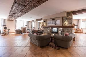 a living room with couches and a fireplace at Hotel Grand Pas in Pas de la Casa