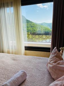 a bedroom with a large window with a view at Vila Tarnita in Cluj-Napoca