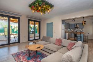 a living room with a couch and a table at Eroğlu Villas in Fethiye