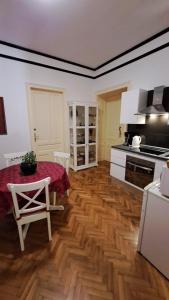 a kitchen with a wooden floor and a table and a stove at Apartmani Belsito in Lovran