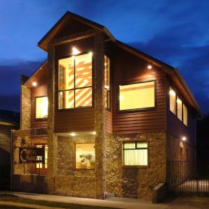 a house with lights on top of it at night at Hotel Carpa Manzano in Punta Arenas
