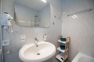 a white bathroom with a sink and a mirror at Perispit in Lefkada +29 photos