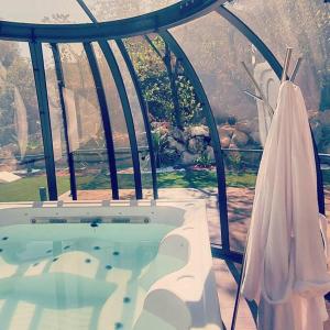 a bath tub in a room with a window at Marseille - Love House Jacuzzi - La Bonne Etoile ! in Marseille