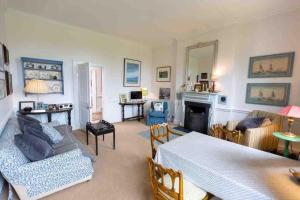 a living room with a couch and a table at The West Wing - Bride Valley - Jurassic Coast in Long Bredy