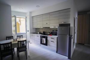 a kitchen with a stainless steel refrigerator and a table at Bnbook-Borromeo 4 Fiera Milano Rho in Rho