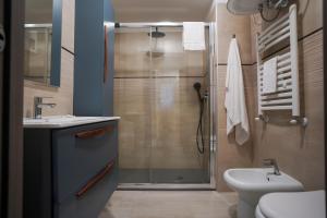 a bathroom with a shower and a sink and a toilet at Bnbook-Borromeo 4 Fiera Milano Rho in Rho
