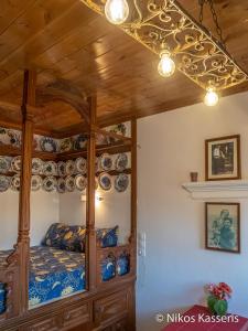 a bedroom with a bed with blue and white china at Olympos apt with amazing mountain view in Olympos