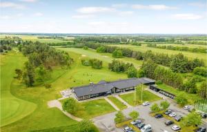 an aerial view of a building with a golf course at 2 Bedroom Cozy Apartment In Pandrup in Pandrup