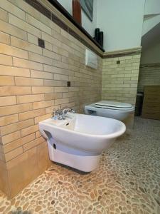 a bathroom with a sink and a toilet at Le Macine in Magnano +40 photos