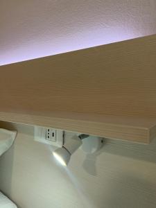 a wooden shelf above a bed with a light under it at Residence Bella in Stari Grad