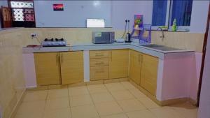 a kitchen with a sink and a counter top at Homestay Luxurious apartments with swimming pool in Mtwapa