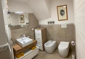 a bathroom with a toilet and a sink at CasaBella Chioggia in Chioggia
