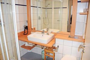 a bathroom with a sink and a shower at Ferienwohnung mit Balkon und Stran in Ostseebad Sellin +18 photos