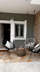 a patio with two chairs and a swing at Julys House in Parga