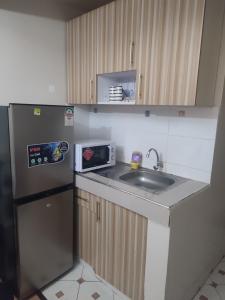 a small kitchen with a sink and a refrigerator at Classy Spacious Studio - Waiyaki Way in Rungiri +41 photos