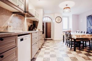 a kitchen with a table and a dining room at Maison Conviviable 3 Vallées in Novallay +14 photos