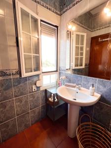 a bathroom with a white sink and a window at Villa Ignacia B&B - Habitaciones & Apartamentos en Plena Naturaleza in Arriate