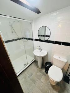 a bathroom with a shower and a toilet and a sink at The Granary in Birchington