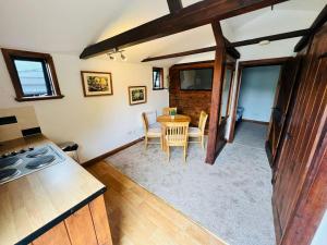 a kitchen and dining room with a table and chairs at The Granary in Birchington