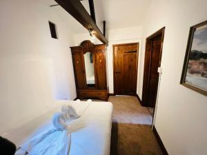 a bedroom with a white bed in a room at The Granary in Birchington