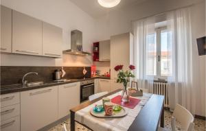 a kitchen with a table with a vase of flowers on it at Beautiful Apartment In Monte San Savino in Monte San Savino