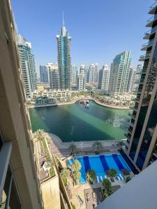a view of a river in a city with buildings at HiGuests - Luxe Apartment With Incredible Marina Views in Dubai