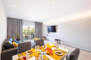 a living room with a table and a couch at #081 T1 Vale Mangude 312 by Home Holidays in Vale de Pedras