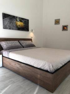 un letto in una camera da letto con foto di un'auto gialla di Domus Alessia a Monserrato