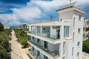 an aerial view of a white building with a balcony at Otto Hotel in Ksamil