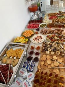 a table filled with lots of different types of food at Otto Hotel in Ksamil